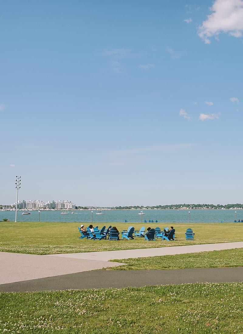 Blue chairs on the campus center lawn.